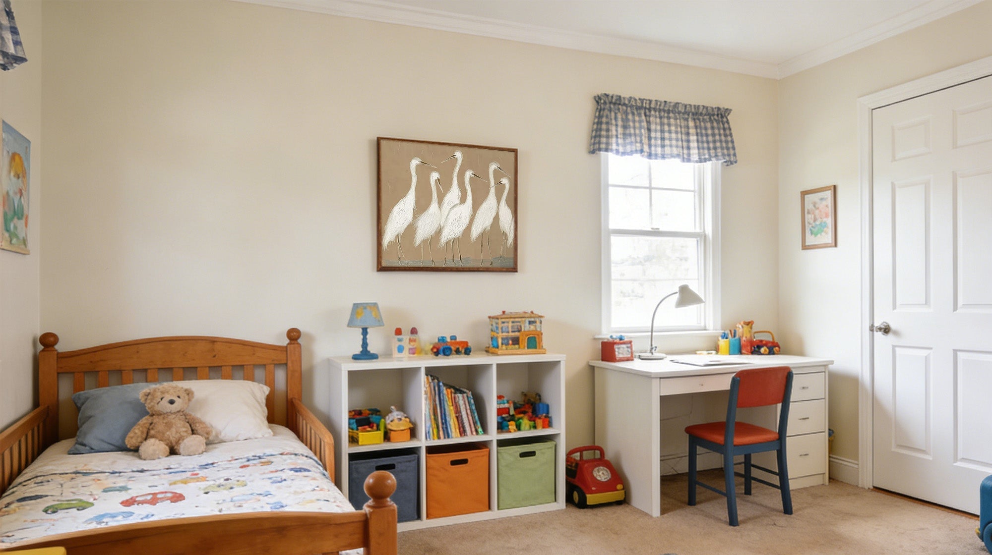 Painting of four white egrets (herons) hanging above a white toy storage unit in a child's bedroom.