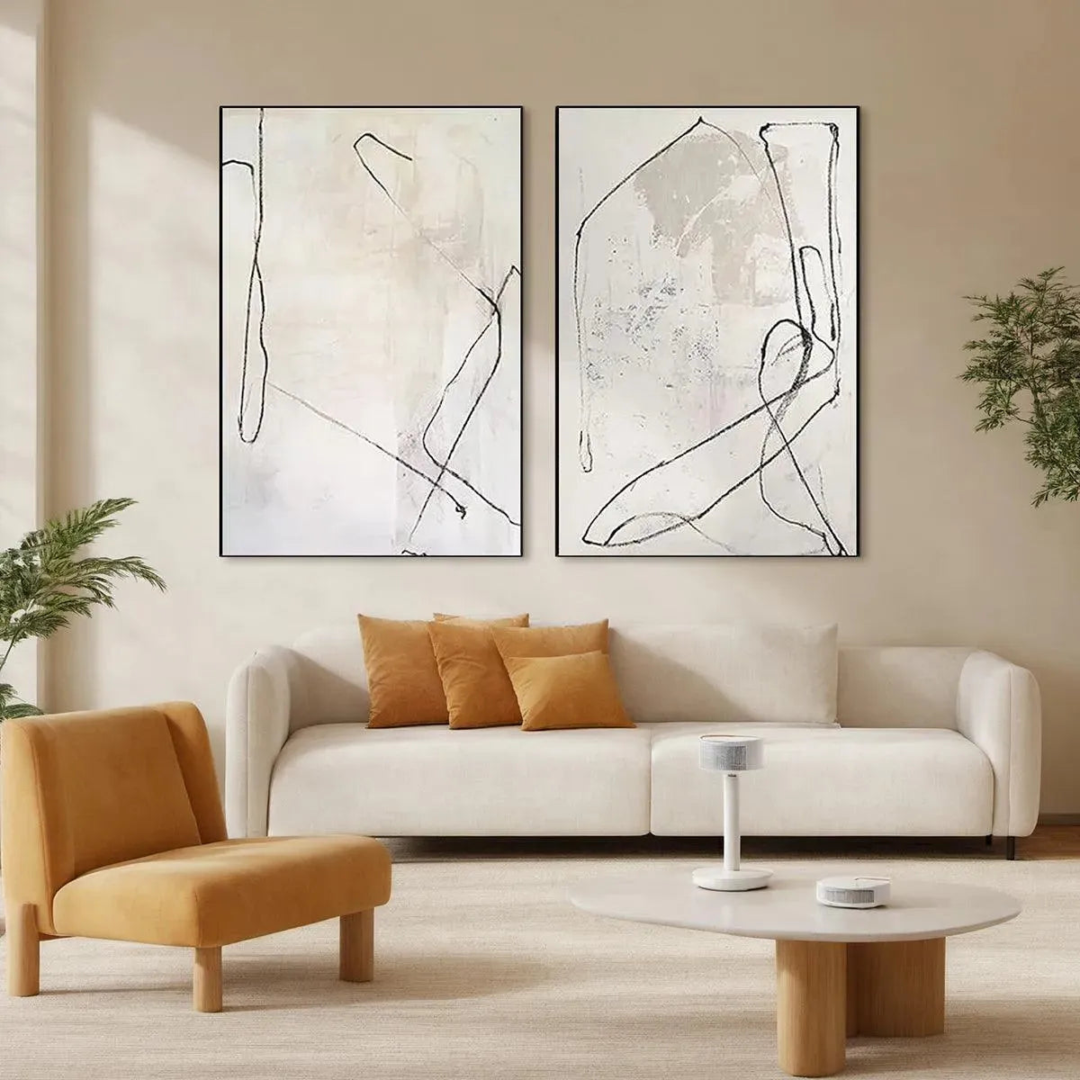 Set of 2 beige abstract paintings with black organic lines displayed in a modern living room.
