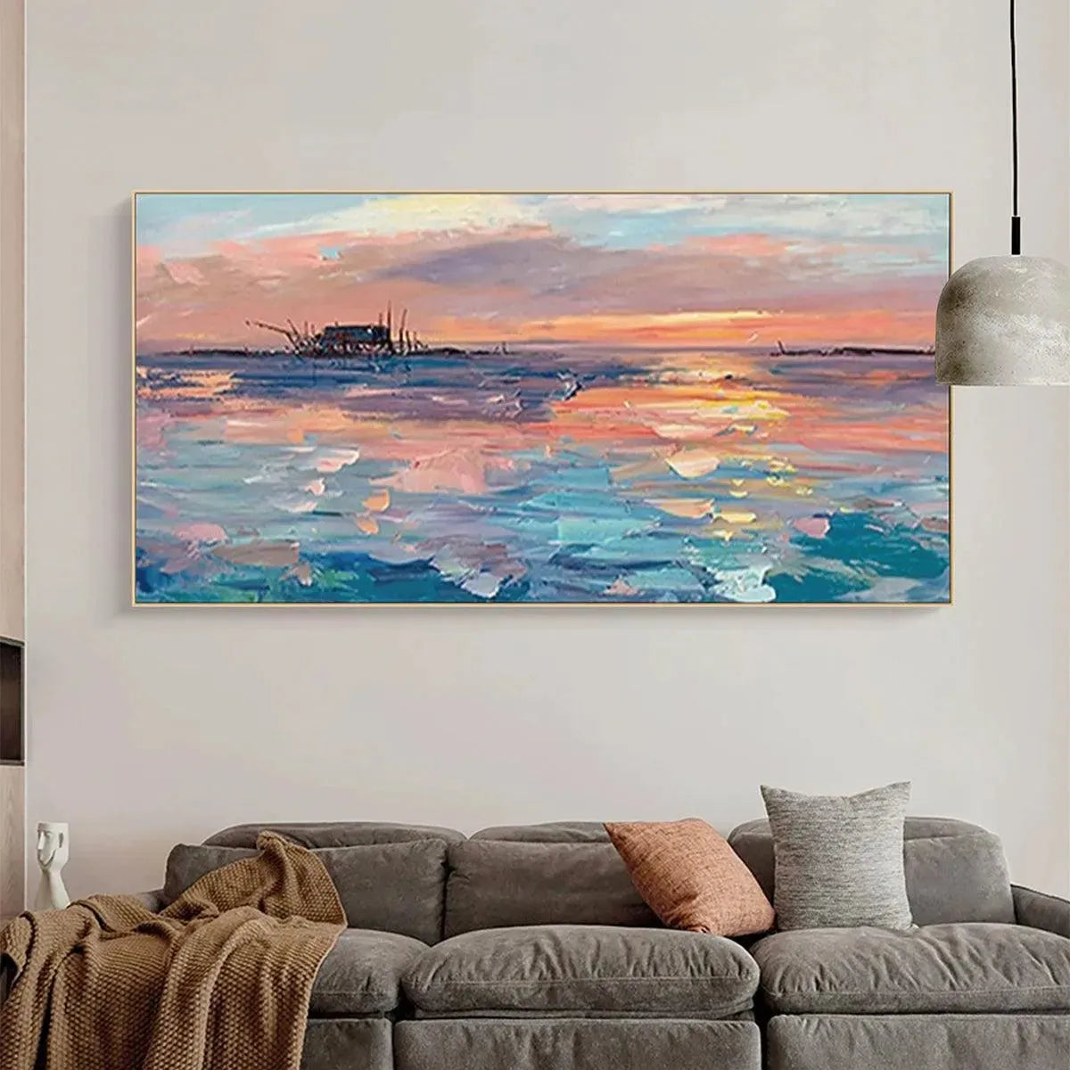 Panoramic coastal sunset oil painting with fishing boat, gold frame, above gray sofa. Minimalist wall art for living room.