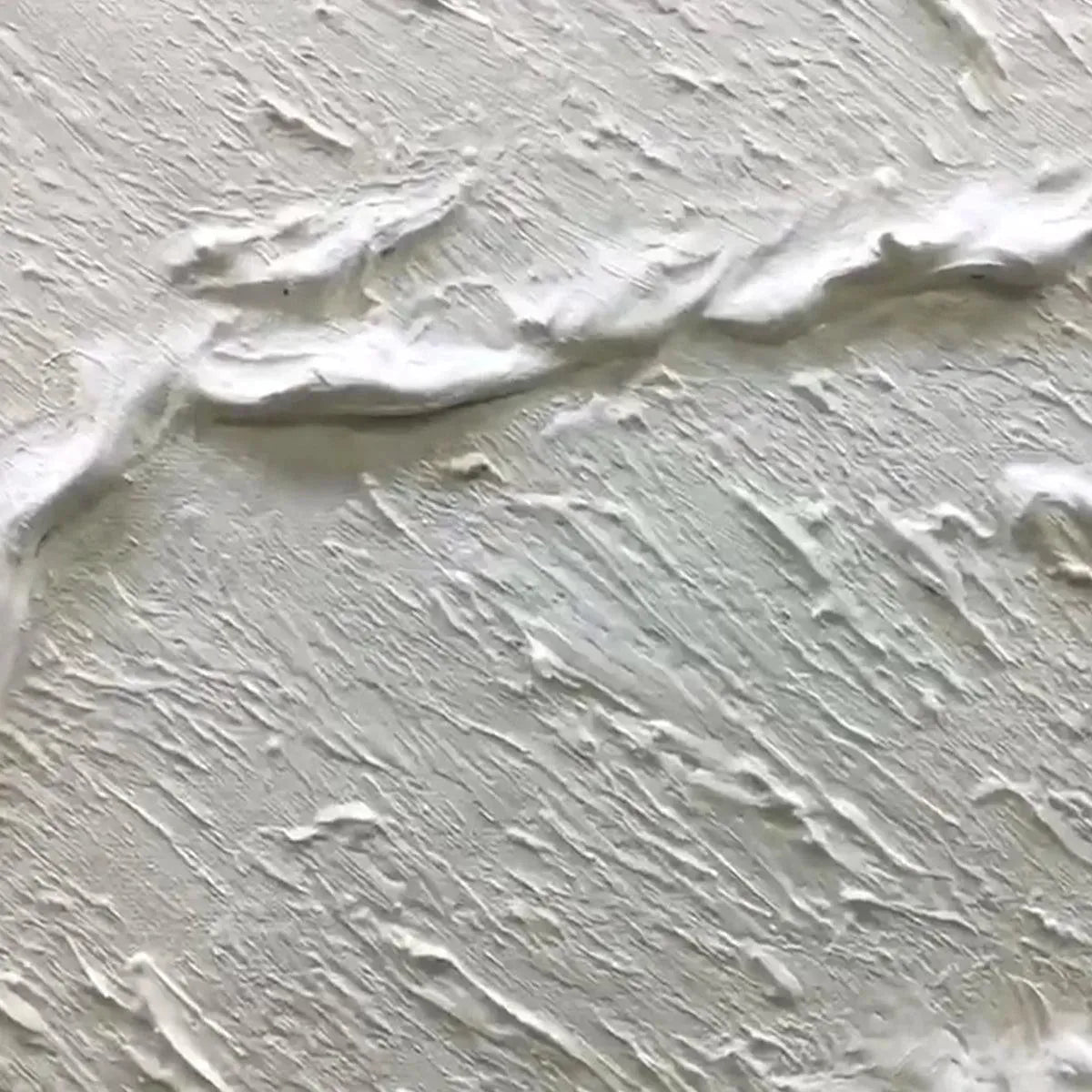 Textured white wave abstract painting close-up, showing impasto detail on beige background.