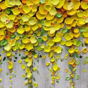 Close-up of Elodie Dubois' Golden Cascade painting showcasing thick impasto yellow floral texture on grey background.