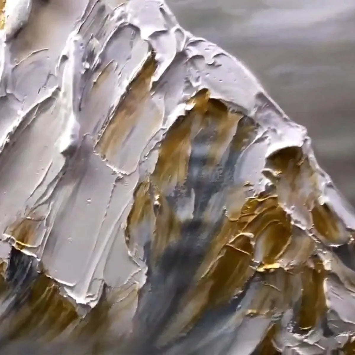 Textured impasto painting of snow-capped mountains in gold and grey, showcasing product appearance and texture.