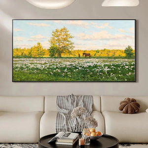 Sunlit Meadow landscape painting with horse and figure, framed above a sofa in a modern living room.