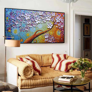Lilac Dream textured floral oil painting with purple blossoms and gold branch above woven sofa in modern living room.