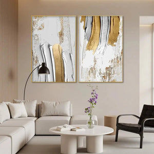 Golden Lines Diptych: Two textured vertical impasto paintings in gold, silver, and white displayed above a sofa.