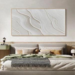 Abstract textured white Serene Ripples painting with ripple patterns, in natural frame, accenting a modern bedroom.