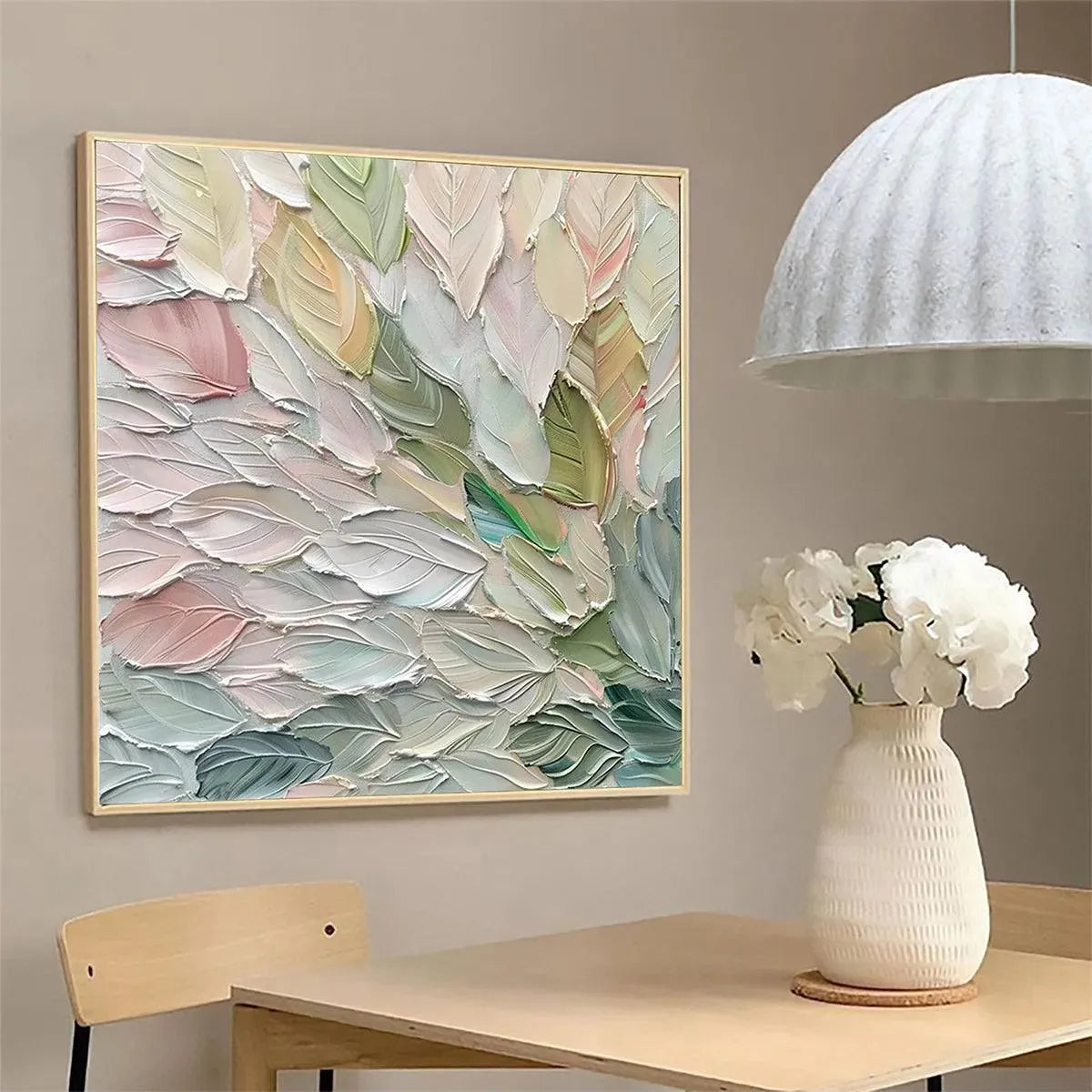 Pastel Dream impasto painting with thick textured pastel leaf shapes in a light wood frame, displayed in a room setting.