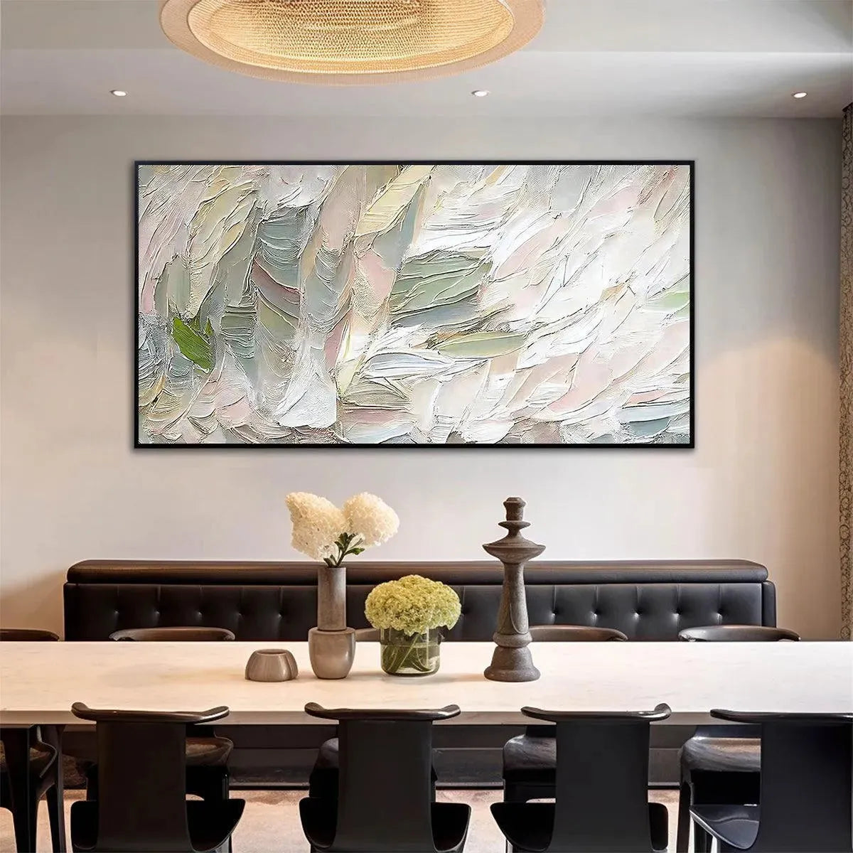 Pink Whispers textured abstract painting in pink, green, and white above dining table.