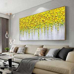 Golden Cascade painting: Textured yellow flowers cascade on grey background, gold framed impasto art in living room.