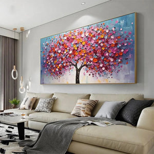 Textured impasto painting of a vibrant tree with pink, orange, blue & yellow jewel-toned leaves above a sofa.