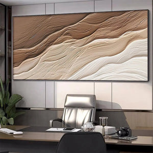 Textured abstract landscape painting 'Desert Flow' in brown and beige, displayed above a desk in a modern office.