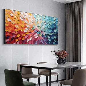 Abstract impasto painting Rainbow Burst in dining room. Horizontal artwork with bold strokes from red/orange to blue/purple.