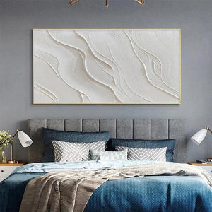 Elodie Dubois's Serene Ripples textured white abstract art in gold frame, bringing calm to a modern bedroom setting.