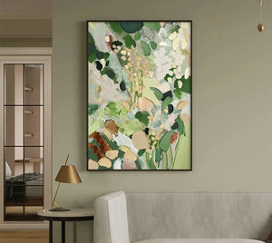 'Whispering Meadow' abstract floral art in green and gold, shown in a living room lifestyle setting.