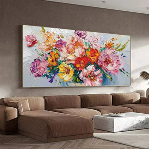 Vibrant impasto floral bouquet painting by Isabella Rossi above a modern sectional sofa in a living room setting.