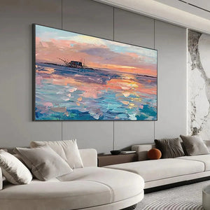 Dusk Reflections panoramic coastal sunset art with shipwreck, large scale in modern living room above gray sectional sofa.