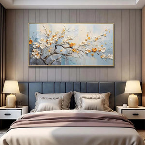 Textured white & gold 'Spring Blossoms' floral painting above a blue bedroom headboard, perfect for modern decor.
