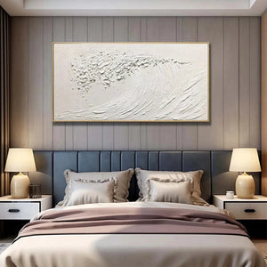 White Wave minimalist ocean wave painting by Liam O'Connell. Textured white art, framed, displayed in a bedroom.