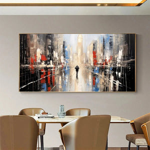 Javier Ramirez's 'Urban Solitude' cityscape art, solitary figure & red/blue tones, adds contemporary style to dining space.