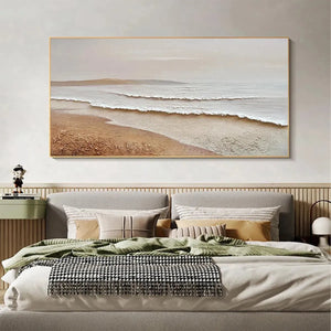 Liam O'Connell's 'Whispering Tides' textured coastal painting in beige and white, framed, above bed. Beach scene artwork.