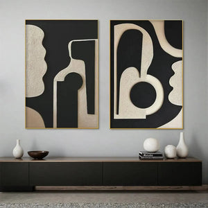 INK BLOT DUO: Two framed abstract paintings with textured beige organic shapes on black background, gold trim.