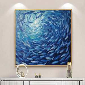 Dynamic Oceanic Whirl blue fish art in gold frame, displayed above a white console, perfect for modern living spaces.