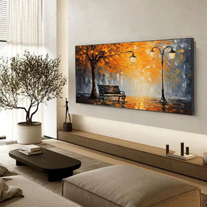 Original impressionistic oil painting of autumn park bench with orange tree and streetlights in modern living room.