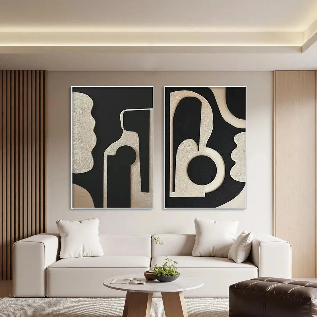 INK BLOT DUO: Two framed abstract paintings with textured black and beige organic shapes above a sofa.