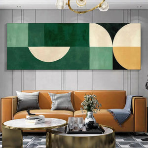 Green geometric panoramic abstract painting with cream and mustard accents above a caramel sofa in a minimalist living room.