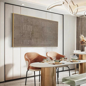 Minimalist brown textured painting by Javier Ramirez in a modern dining room setting, featuring a rectangular pattern.