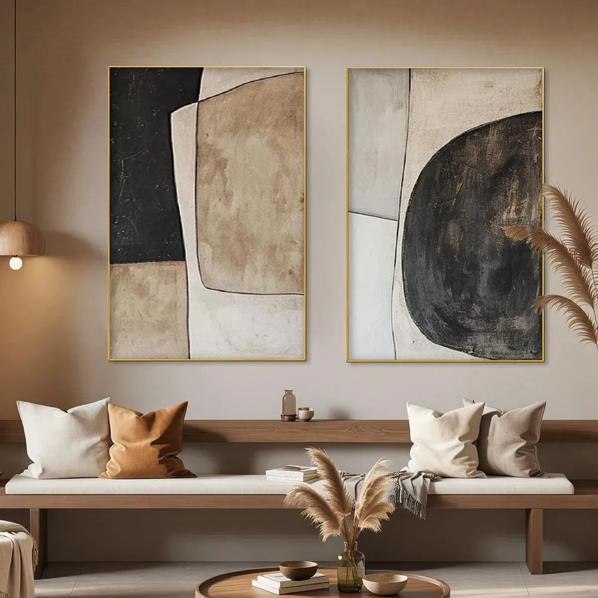 Abstract geometric diptych wall art set in beige and black, with gold frames, displayed in a living room.
