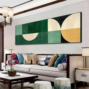 Green Geometric Panoramic wall art with cream, mustard, and black accents above a modern sofa.