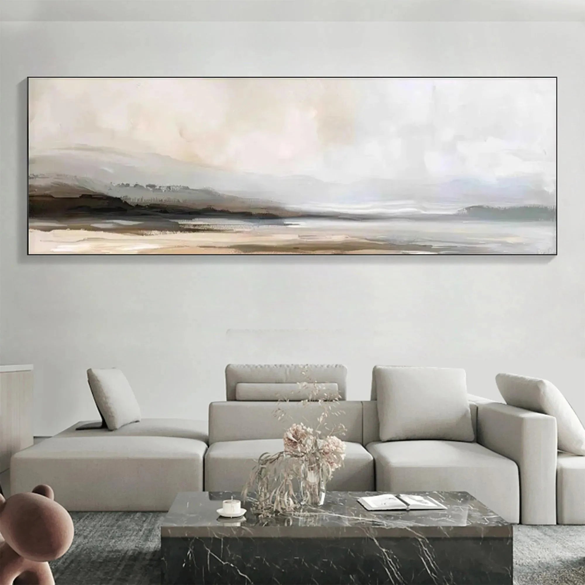 Liam O'Connell's Misty Mountain Lake Panoramic wall art in muted earth tones above a sofa.