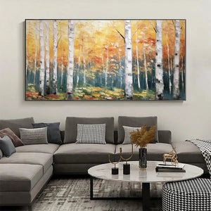 Horizontal Golden Birch Grove painting above modern grey living room sofa, showcasing home decor integration.