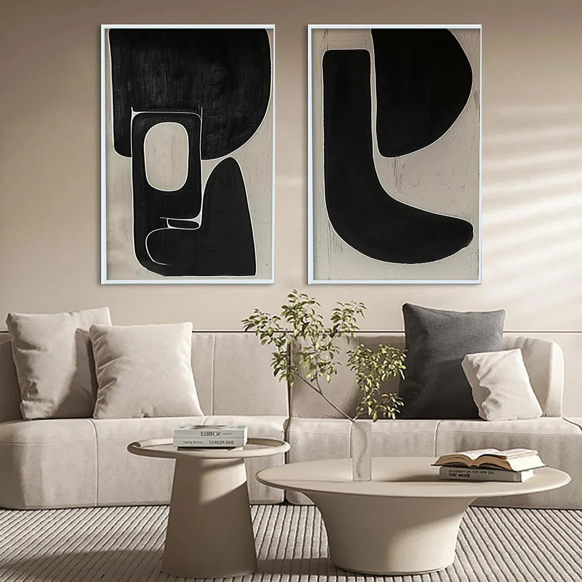 Black and beige abstract diptych wall art set by Javier Ramirez, displayed in a modern living room above a sofa.