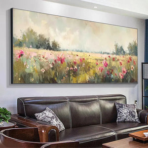 Panoramic impressionist painting of a wildflower field with pink flowers above a brown leather sofa.