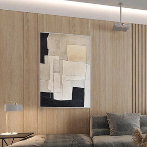 Minimalist abstract painting in beige and black geometric shapes by Javier Ramirez in a modern living room setting.