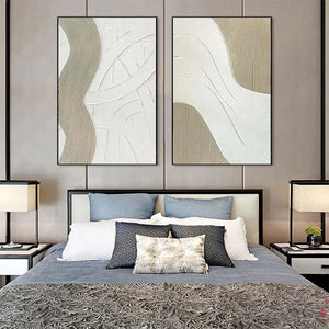 Textured White Lines Diptych: Two framed minimalist paintings with raised white and beige lines displayed above a bed.