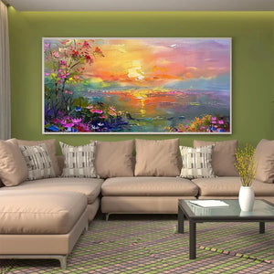 Vibrant watercolor sunset landscape art with wildflowers, adorning a modern green living room above a beige sectional sofa.