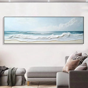 Liam O'Connell textured ocean waves painting, 60"x20", serene blue beach art displayed above sofa.