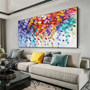 Vibrant textured impasto floral painting with cascading purple, orange, teal leaves above a living room sofa.
