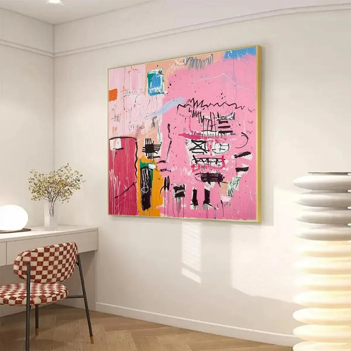 Pink Expression abstract painting, vibrant pink, gold-framed, on wall in modern room with desk & checkered chair.
