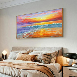 Tropical Sunset Beach painting by Liam O'Connell in gold frame, displayed above a modern bedroom headboard.