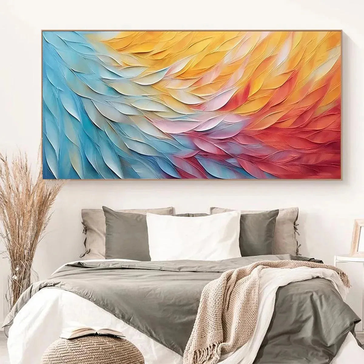 Horizontal abstract wall art with textured impasto waves in blue, yellow, red, and white, showcased above a minimalist bedroom setting.