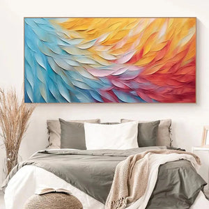 Horizontal abstract wall art with textured impasto waves in blue, yellow, red, and white, showcased above a minimalist bedroom setting.