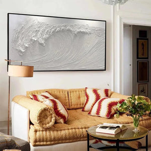 Liam O'Connell's textured white wave painting above a yellow sofa in a living room.