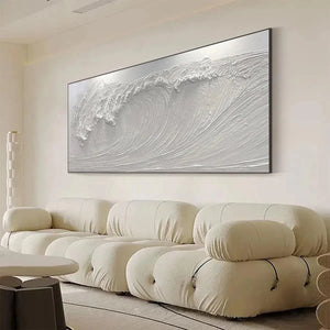 Liam O'Connell's Frozen Tide painting showcasing a textured white crashing wave above a cream sofa in a modern living room.