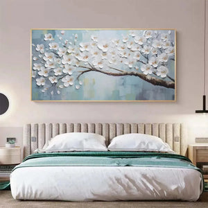 Textured White Blossoms painting with blue background, elegantly integrated above a bed in a modern bedroom.