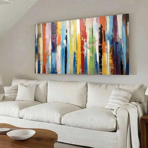 Willow Davies COLOR HARMONY abstract painting: colorful impasto vertical stripes above white sofa.