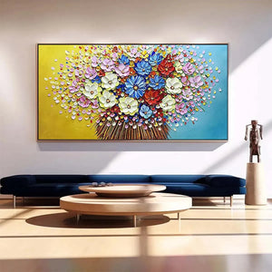 Textured impasto floral painting with colorful blooms on yellow and blue background, displayed over navy sofa.